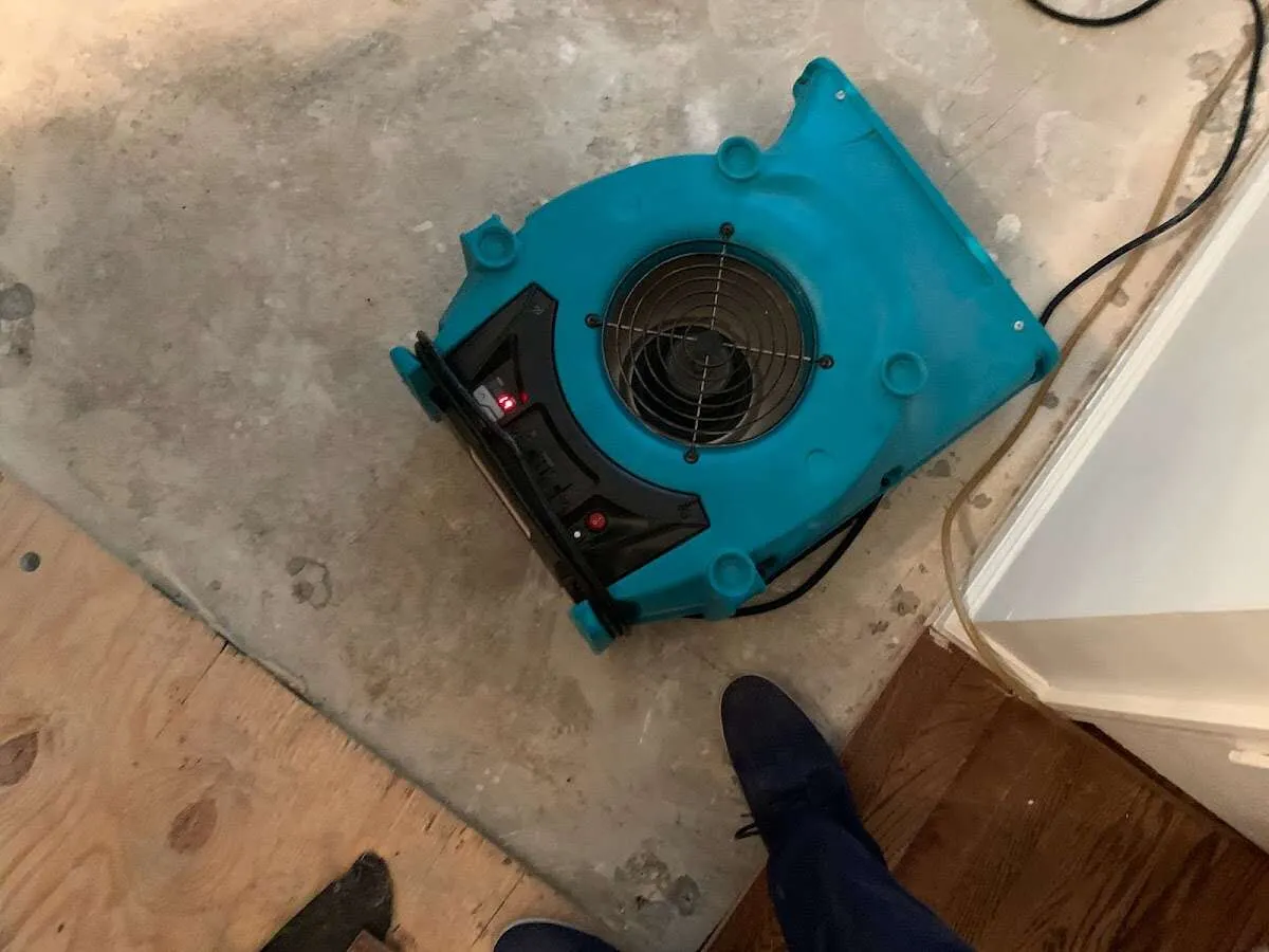Air mover drying subfloor during Commercial Water Damage Restoration in Florin